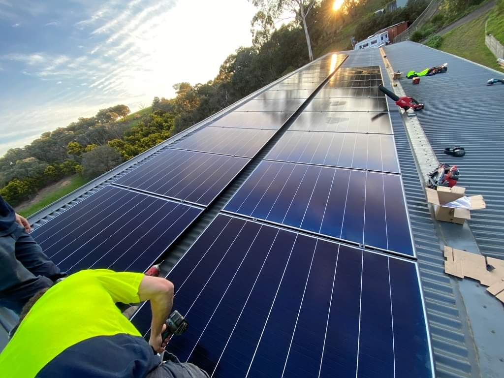 man working on solar penel