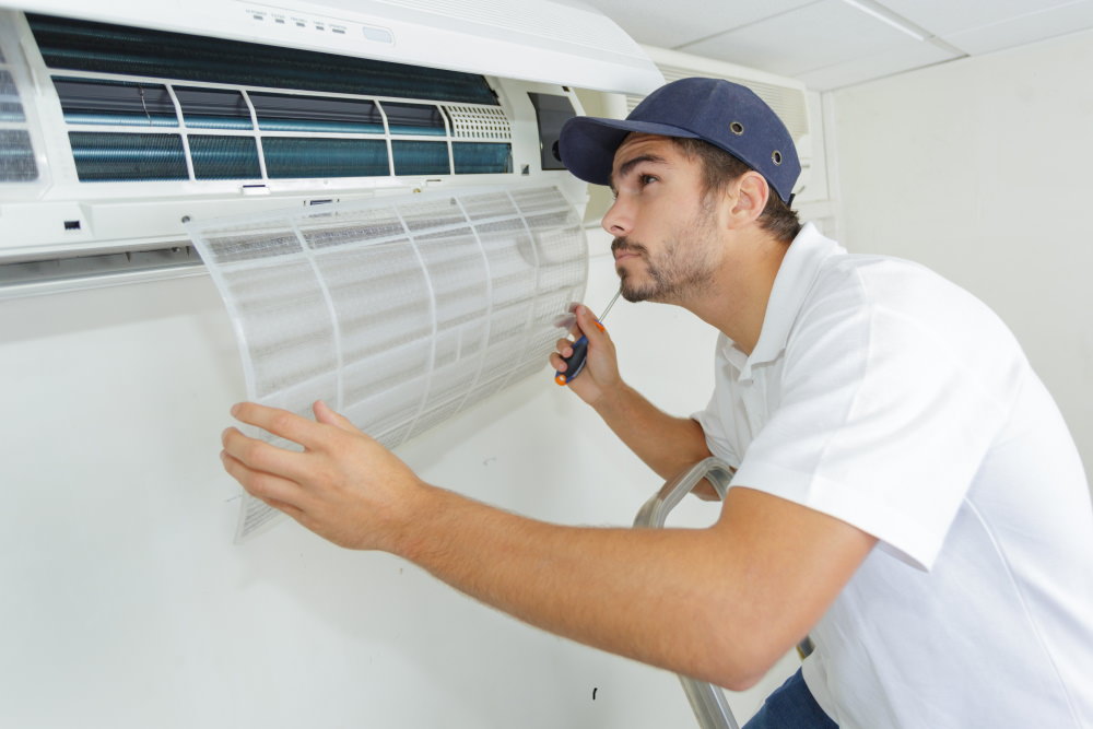 portrait of mid adult male technician-installing split system air conditioning