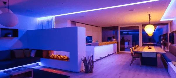 A stylish living room featuring ambient blue and purple lighting, enhancing the space's modern and relaxing vibe