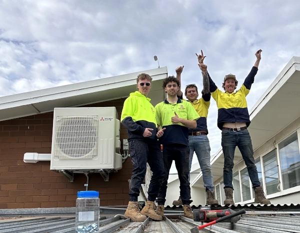 team celebrating after installing air conditioner